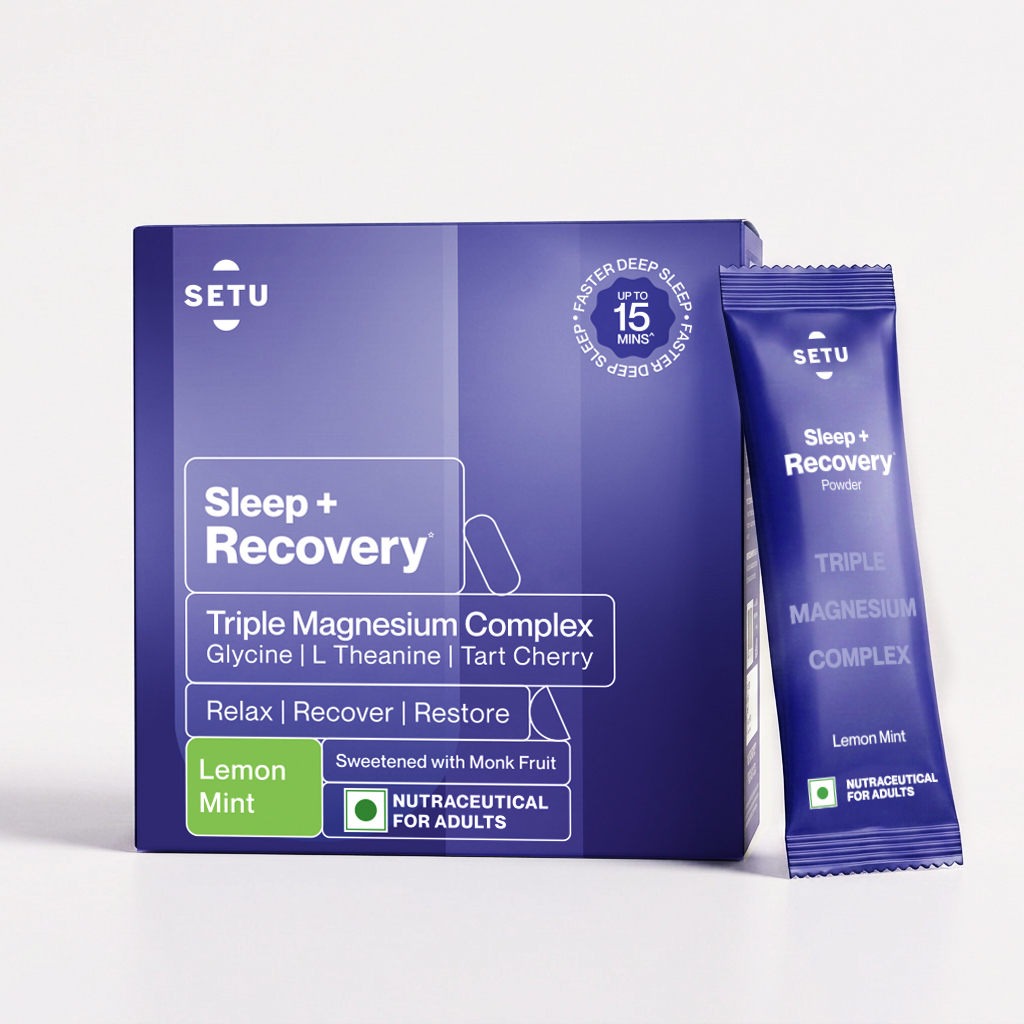 SETU Sleep + Recovery box and sachet beside a tall glass of pale-pink berry-lemonade settle on a warm wood Indian kitchen counter